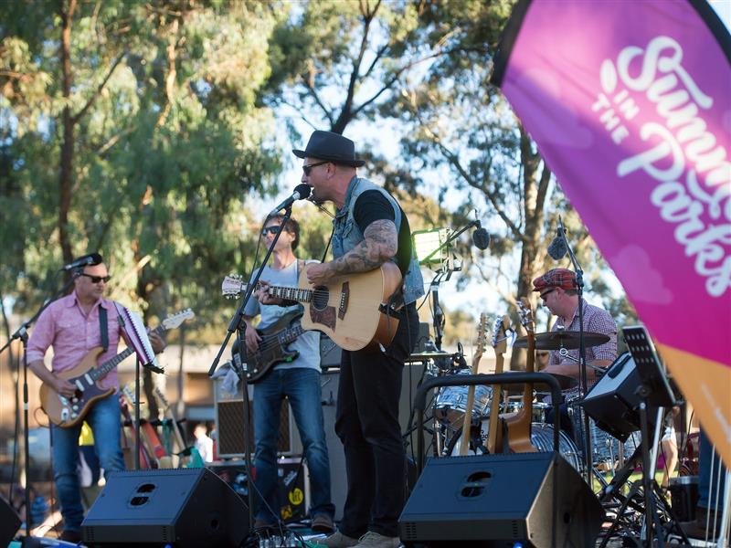 A man singing on a stage holding a guitar