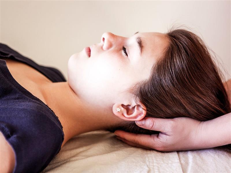 young woman receiveing a Reiki Treatment