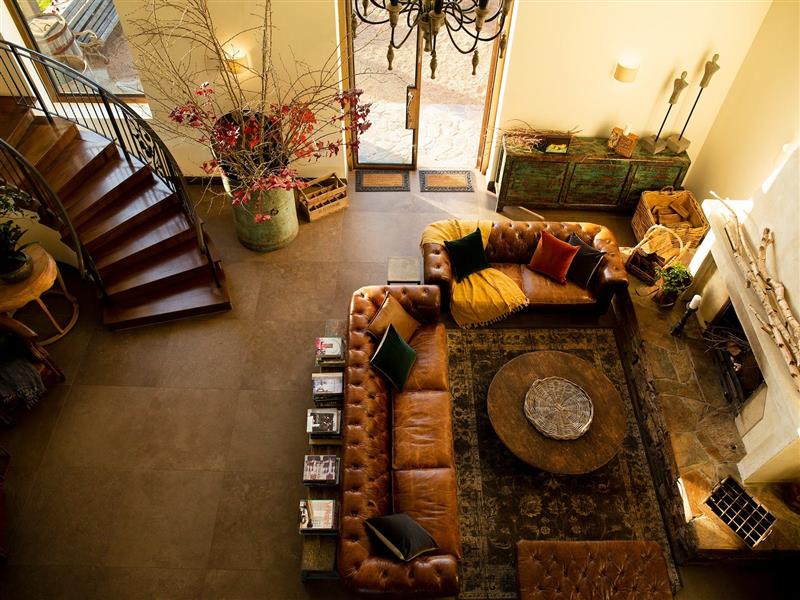 A set of chesterfields in front of a fireplace