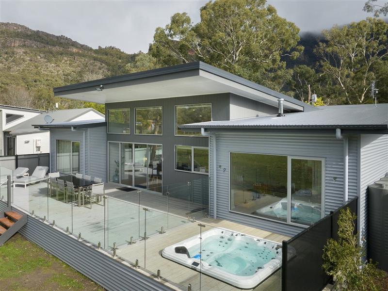 Rear garden with large deck and outdoor dining