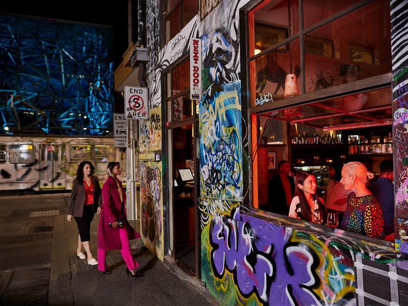 Patrons dining at and walking into Movida Next Door, Melbourne, Victoria.
