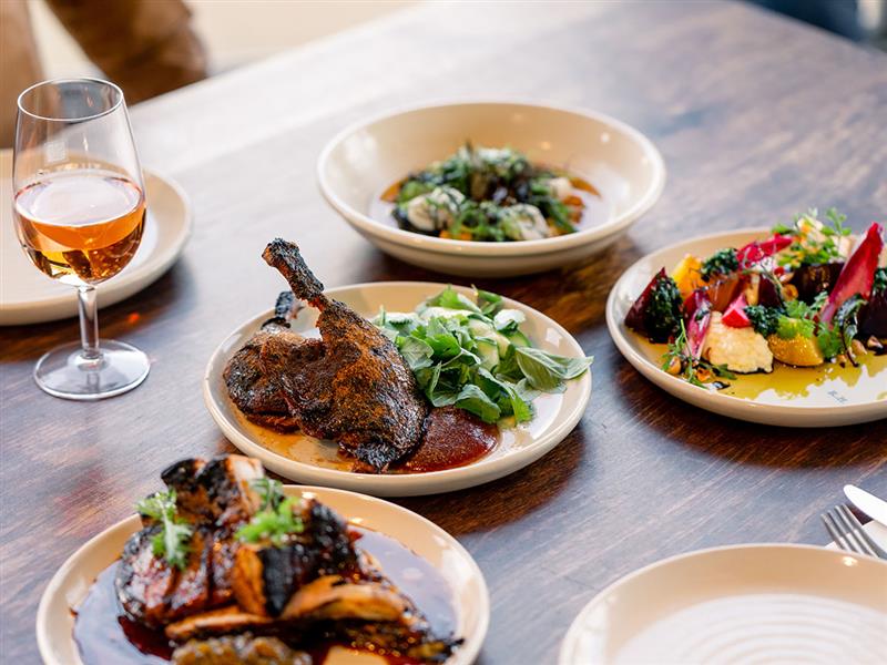 Plates of food held by a server at Rare Hare, Jackalope Hotel, Mornington Peninsula, Victoria